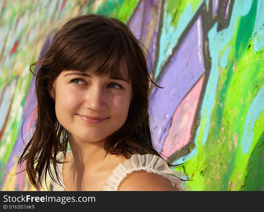 Women's  portrait on a colored wall background. Women's  portrait on a colored wall background