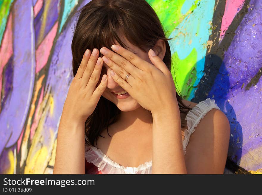 Women's  portrait on a colored wall background. Women's  portrait on a colored wall background