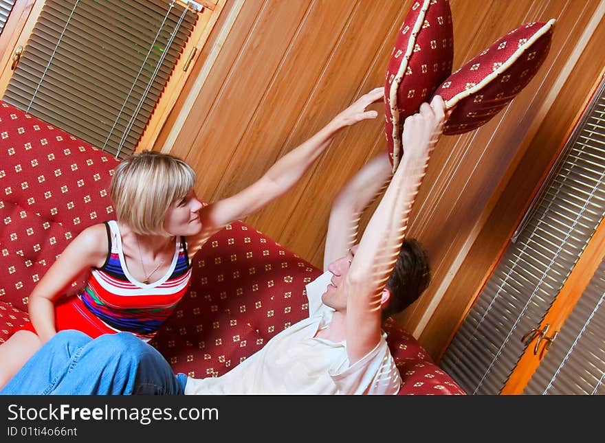 Couple playing with pillows