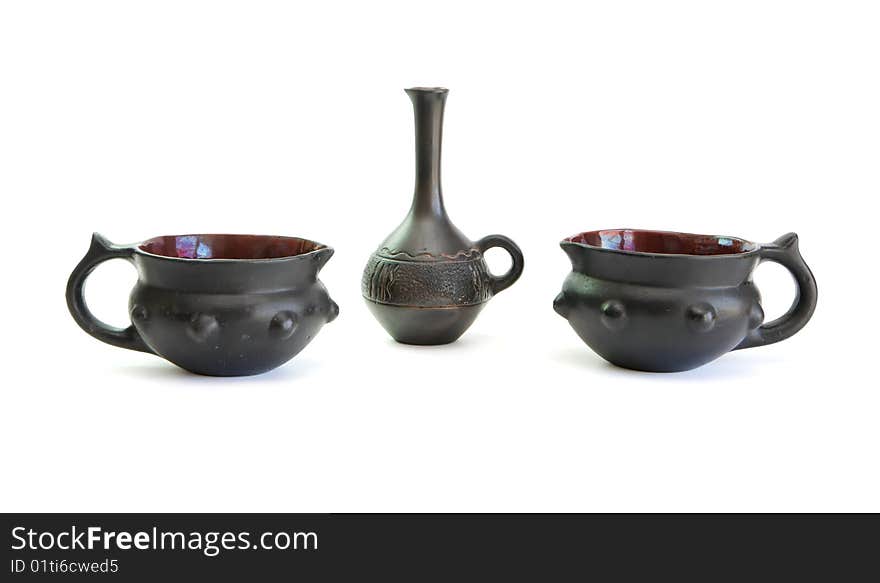 Two black decorative ceramic pots and small jug isolated on white