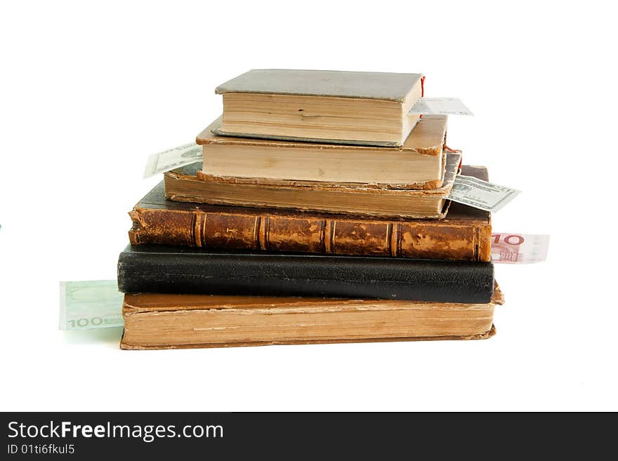 Stack of old books with banknote bookmarks isolated on white