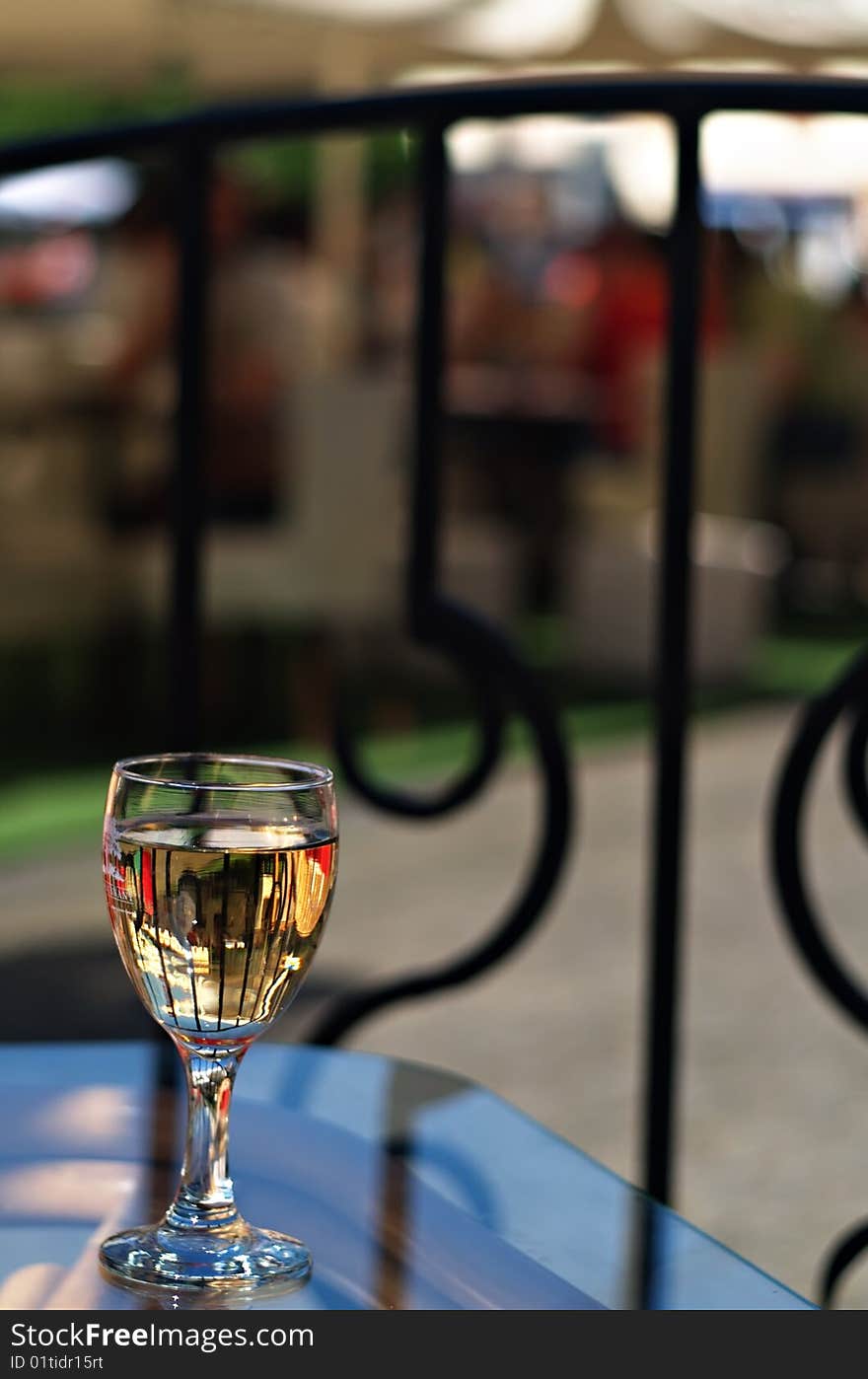 Wineglass in street cafe with shallow dof