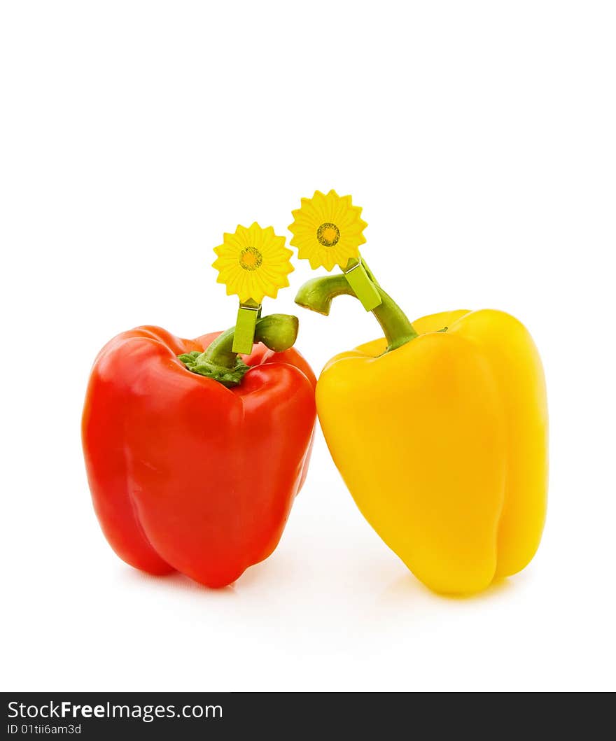 Healthy eating - fresh red and yellow pepper with wooden flower clip isolated on white background. Healthy eating - fresh red and yellow pepper with wooden flower clip isolated on white background.