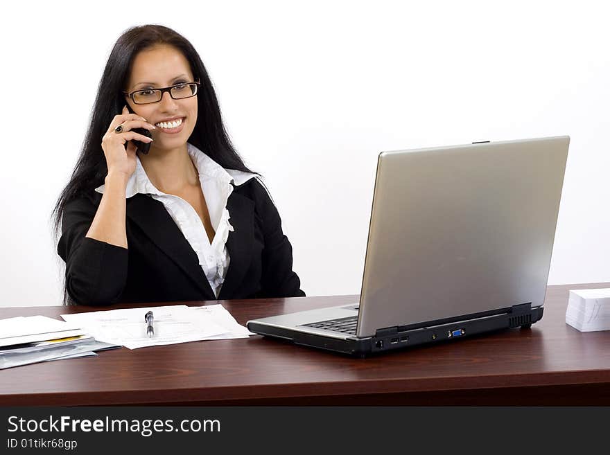 Attractive businesswoman on the phone at her desk