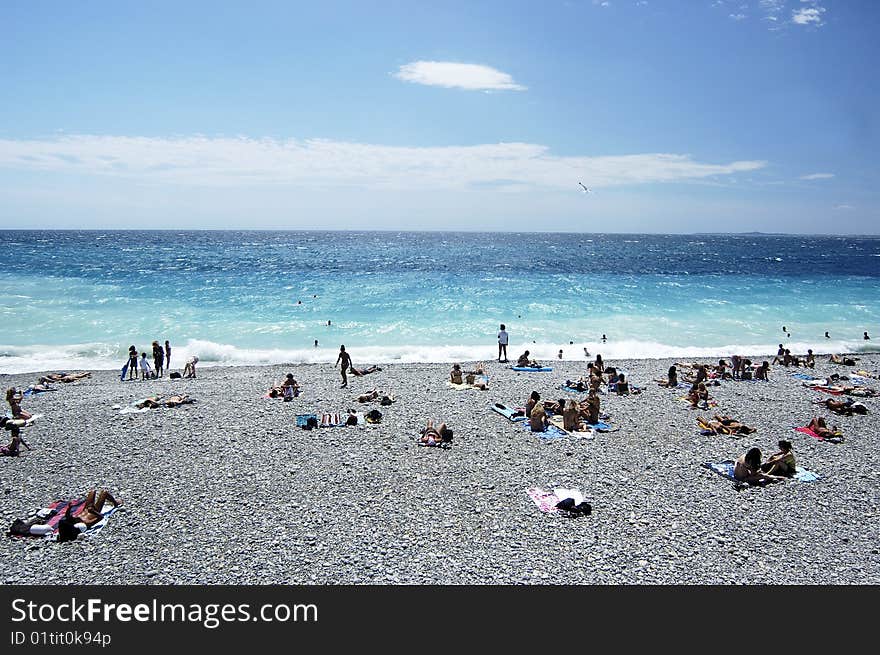 Beach with people in summer time in Nice