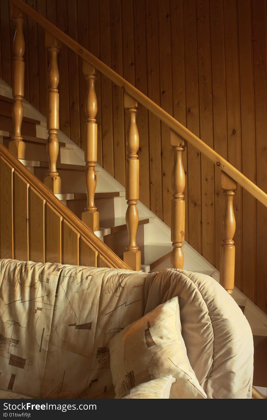 Interior with a wooden ladder and a soft sofa