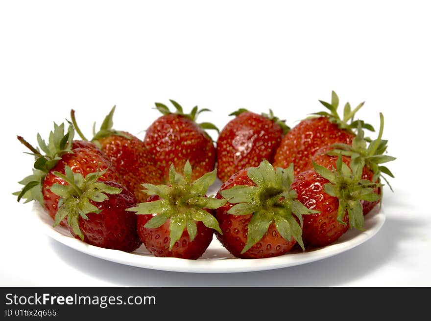 Fresh and tasty strawberries on white plate