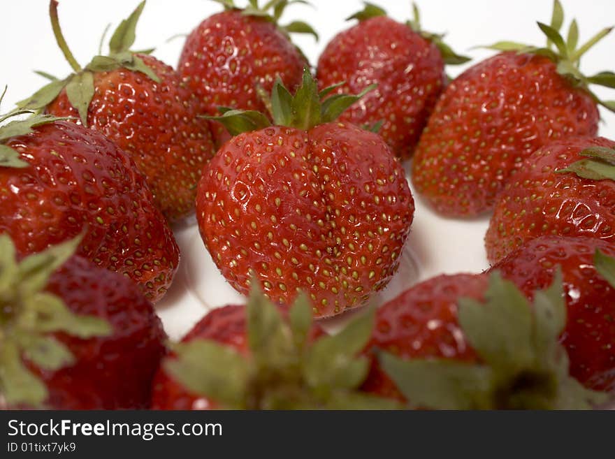 Fresh and tasty strawberries on white plate