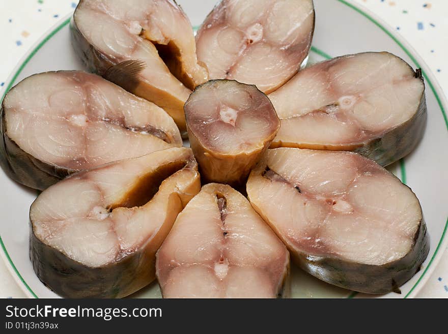 Bit smoked mackerel put on plate on kitchen