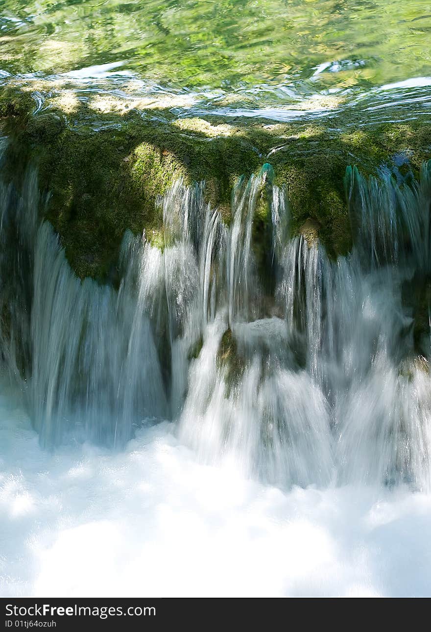 Small waterfall in mountains as background