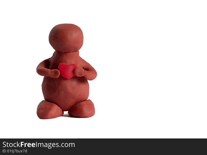 Plasticine man keeping a heart in the hands isolated over white background