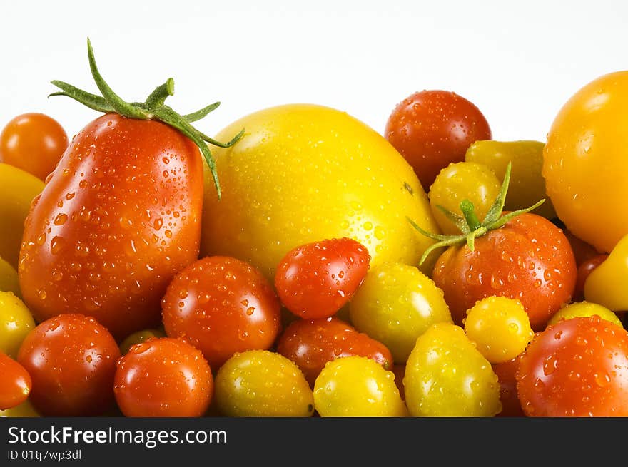 Roma, lemon boy, cherry, yellow pear, red pear tomatoes against a white background.