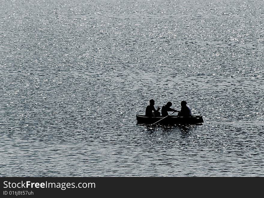 Three persons go boating. Lake. Three persons go boating. Lake