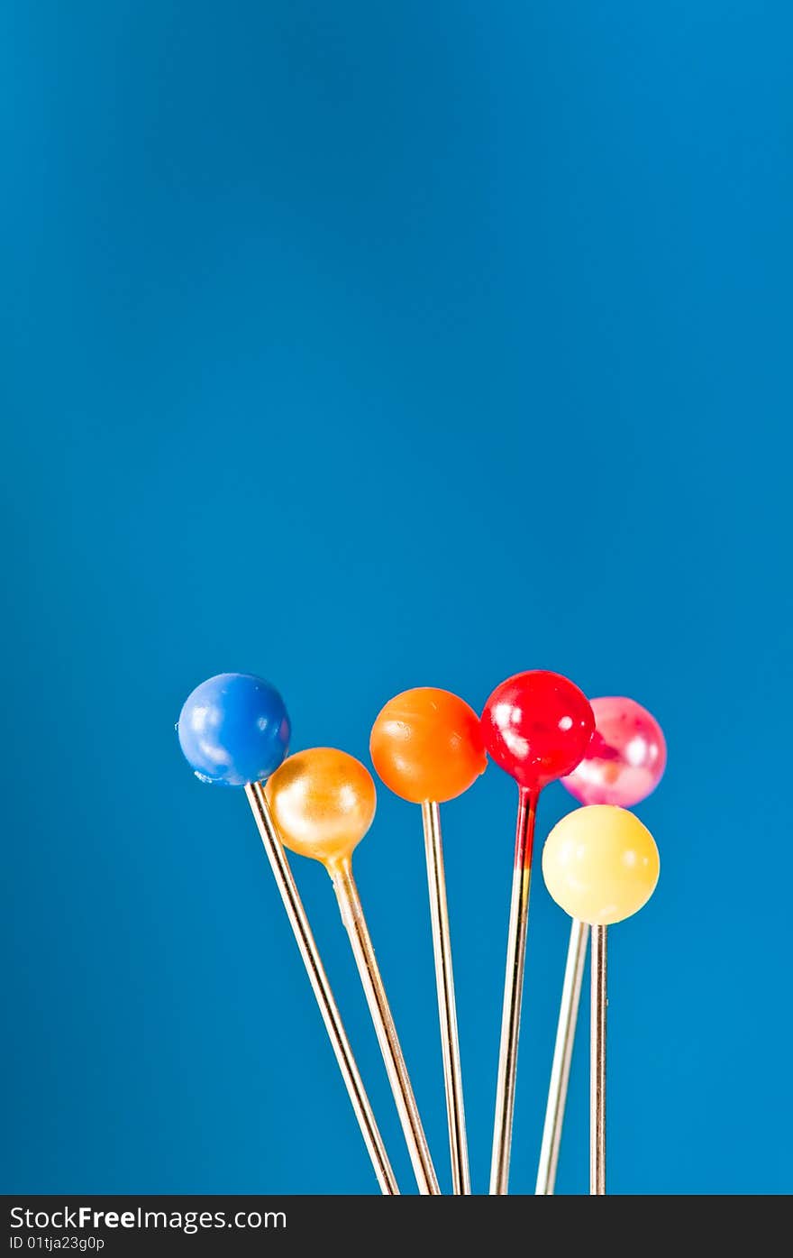 Group of pins with bright  tops in macro