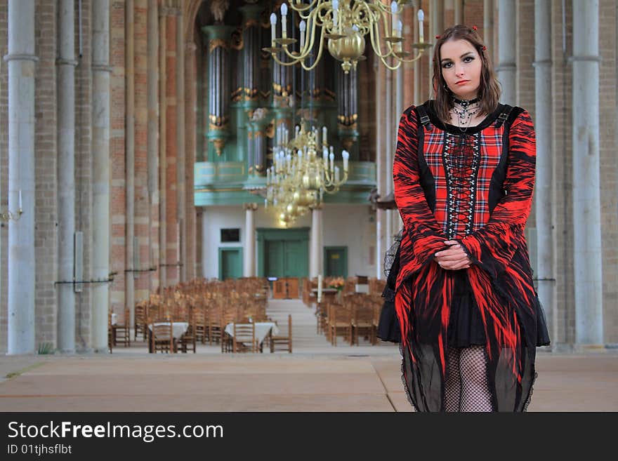 Gothic girl with mini skirt posing inside of a church. Gothic girl with mini skirt posing inside of a church.