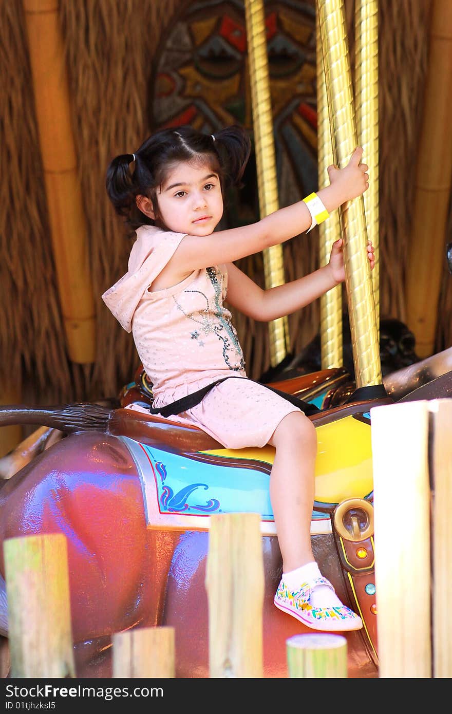 Girl in merry go round in an amusement park