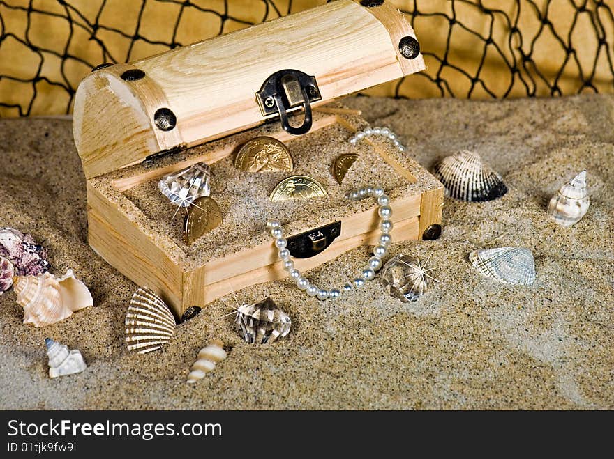 Beads, coins and baubles in a wooden chest. Beads, coins and baubles in a wooden chest.