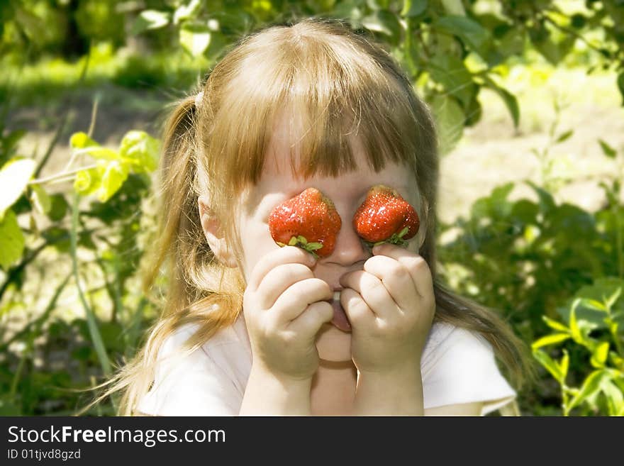 Happy girl hold in the face of strawberries. Happy girl hold in the face of strawberries