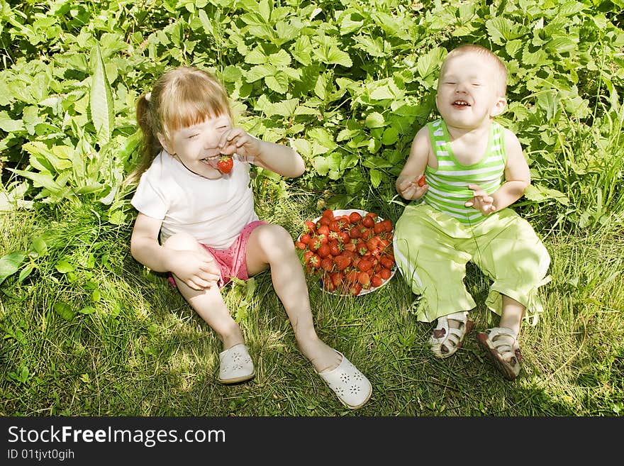 Little Girl and Boy eating ripe strawberries. Little Girl and Boy eating ripe strawberries.