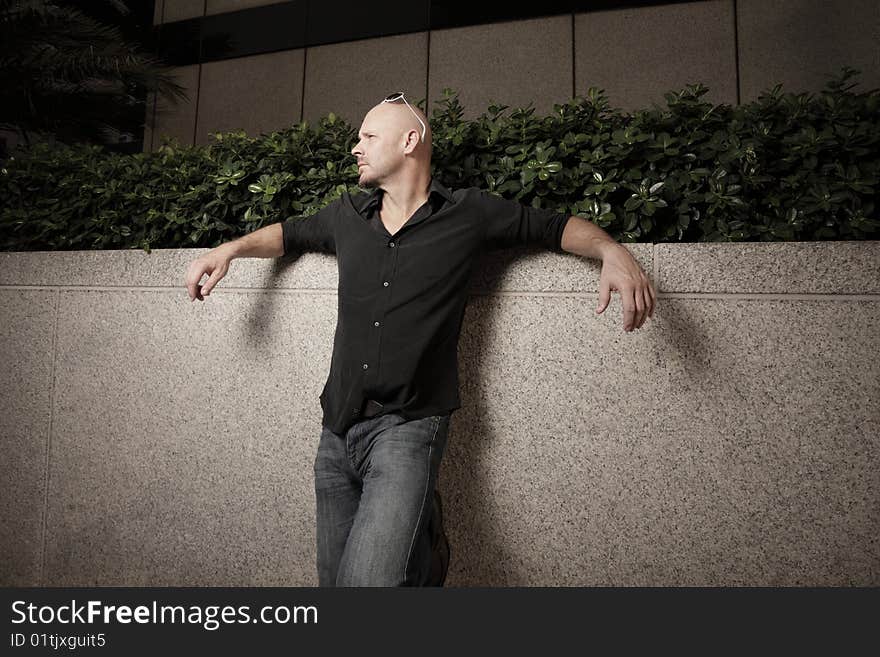 Man posing by a wall