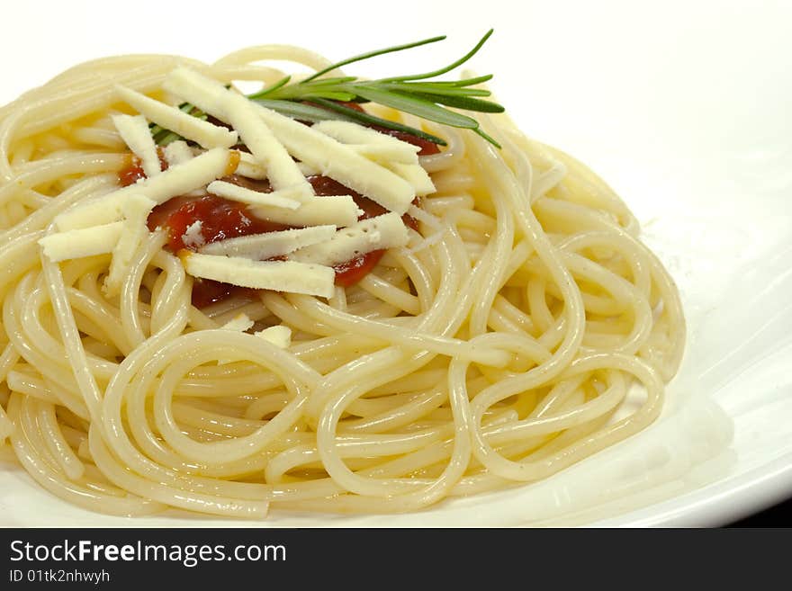 Portion of spaghetti with tomato sauce on a white plate