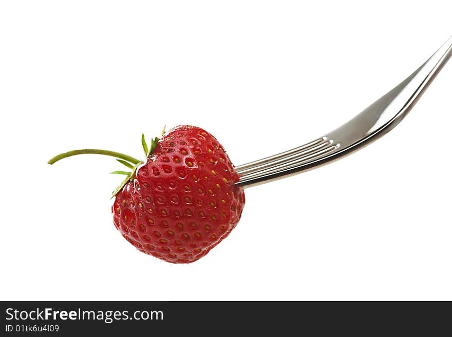 Strawberry on a fork on white background