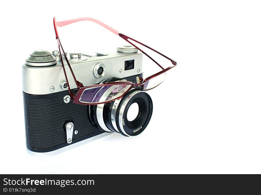 Vintage camera with eyeglasses on lens isolated on white. Vintage camera with eyeglasses on lens isolated on white.