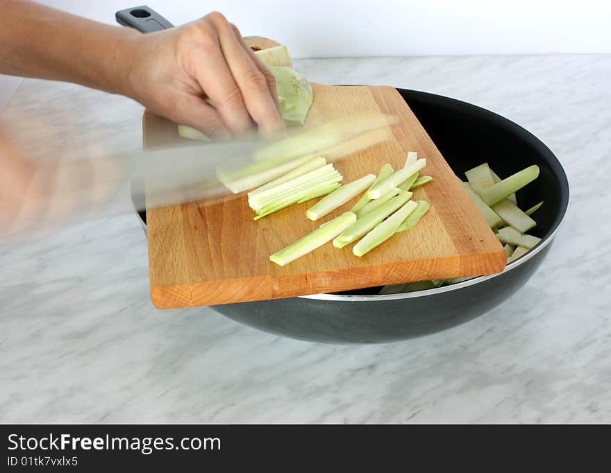 Hands cuting fresh vegetable