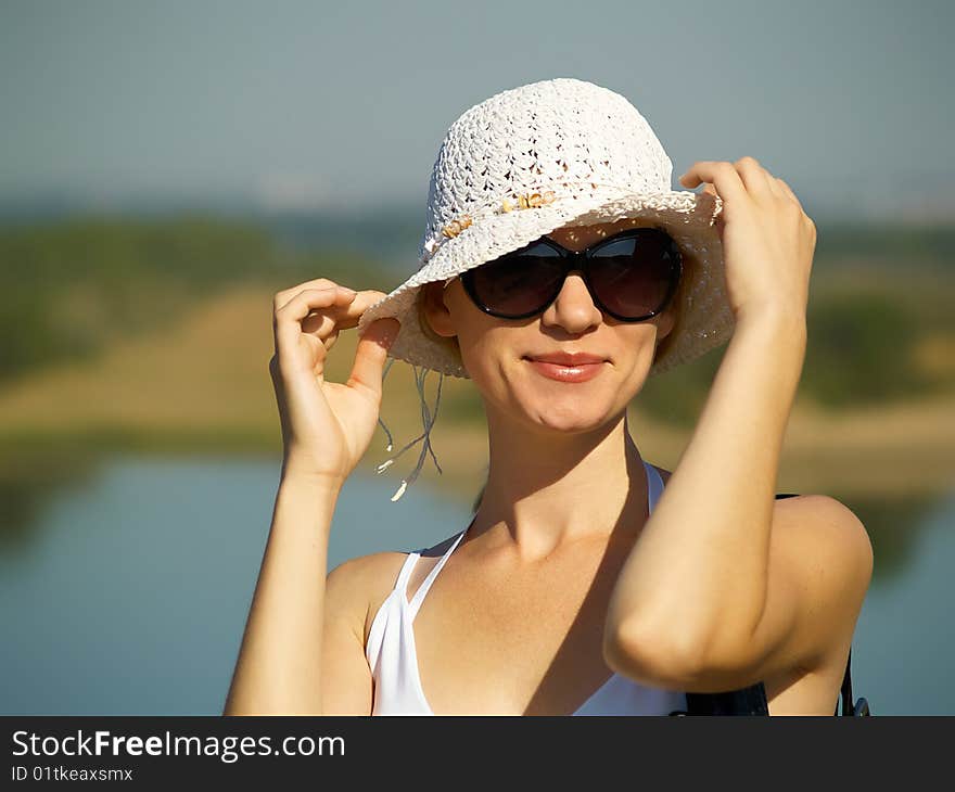 The young woman in white clothes on rest in the summer on the nature