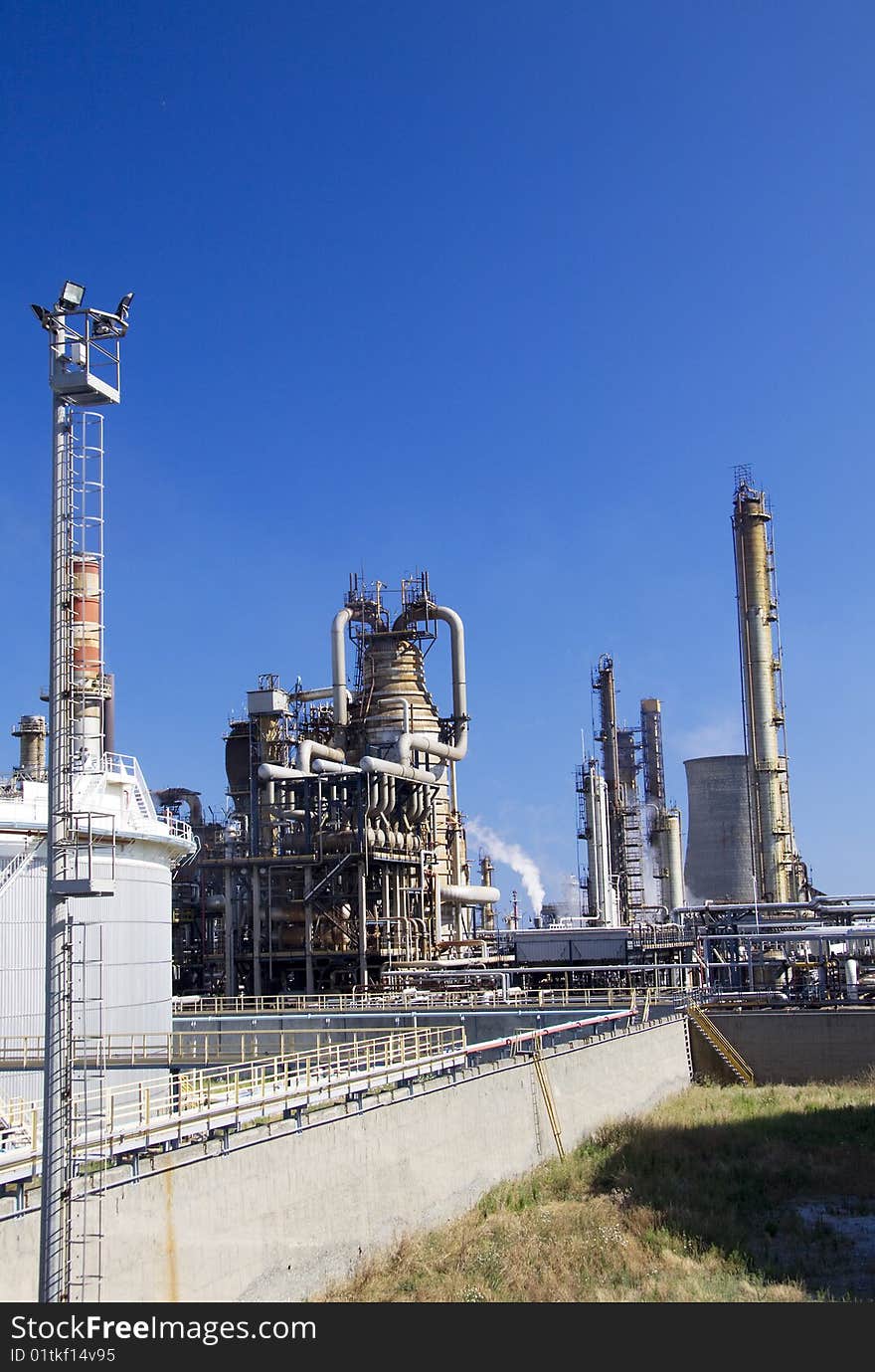 Oil refinery in Italy with tall smokestacks. Oil refinery in Italy with tall smokestacks