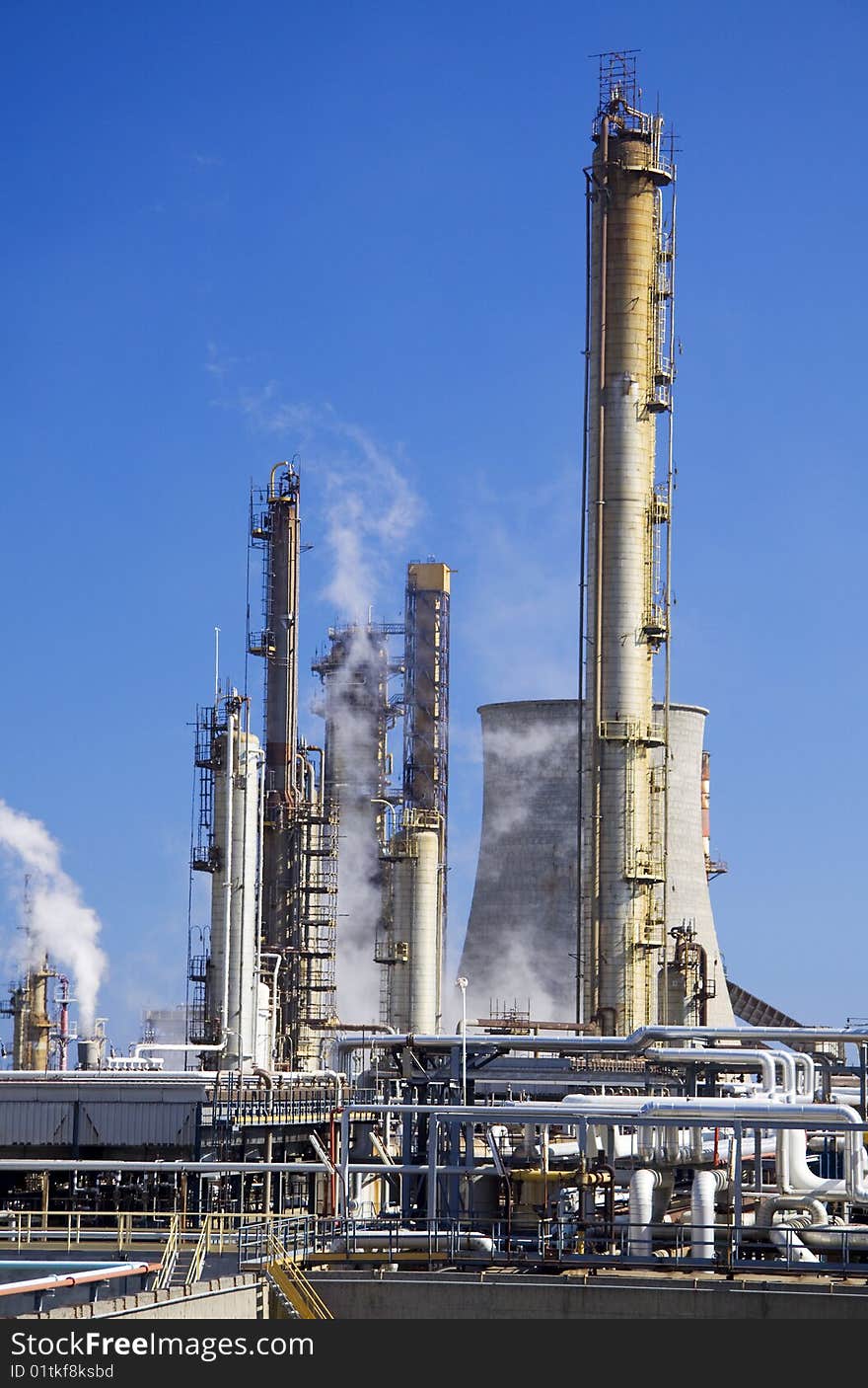 Oil refinery in Italy with tall smokestacks. Oil refinery in Italy with tall smokestacks