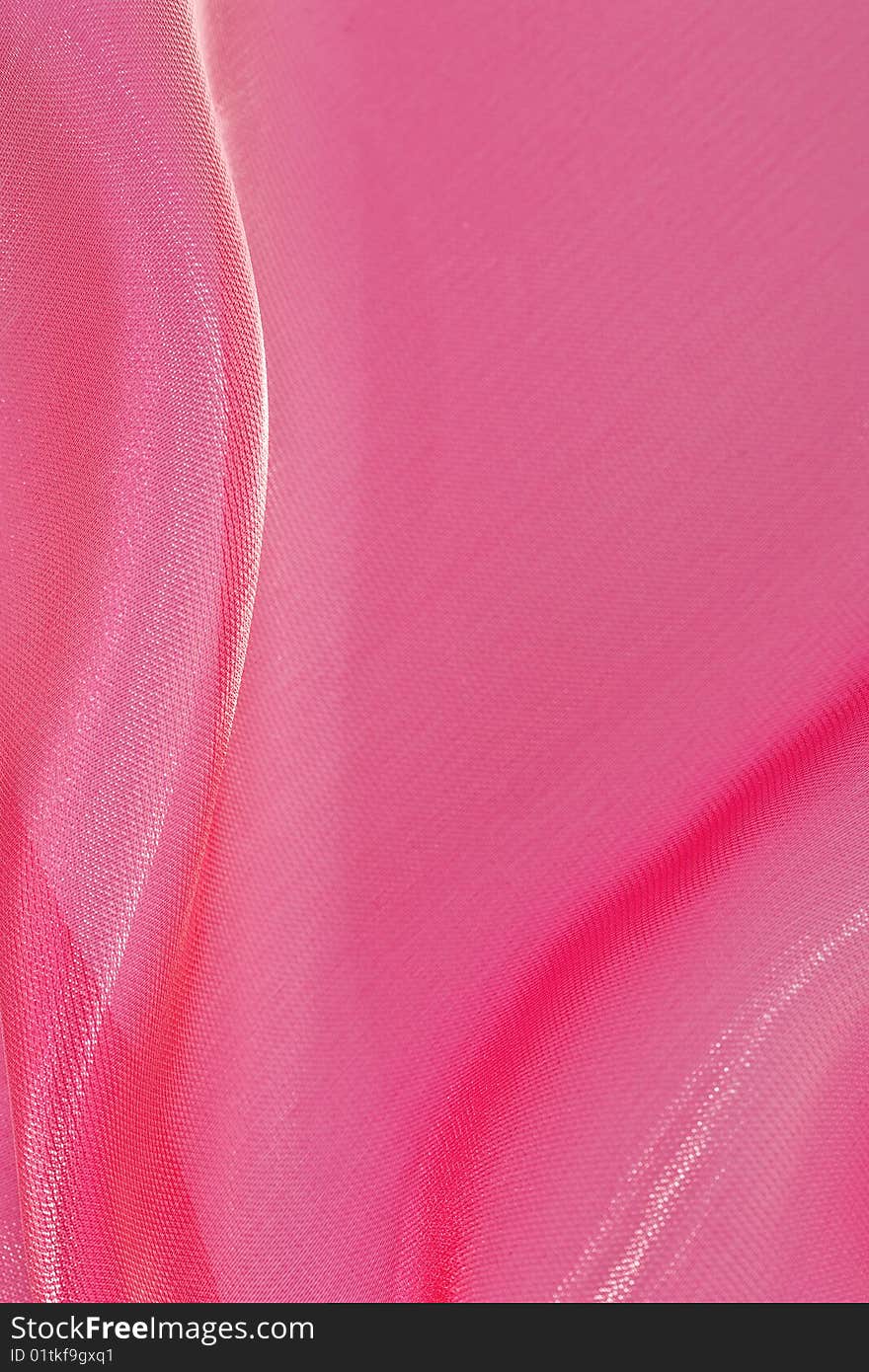 Abstract background of gentle folds of red silk