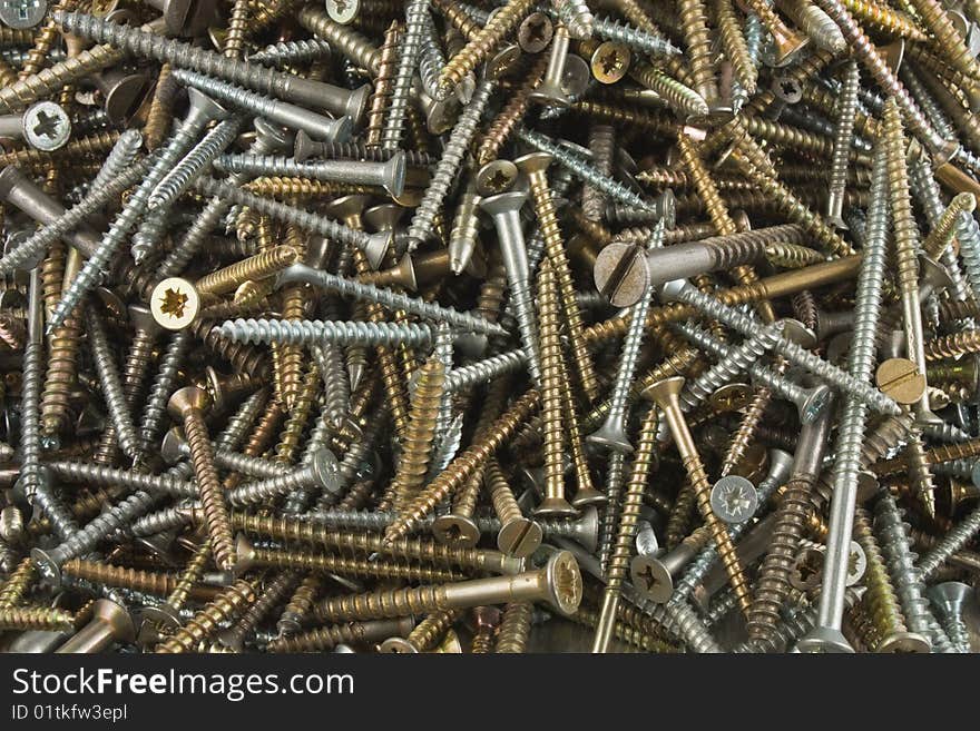 Texture of different screws in white and yellow metal