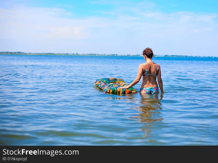 Girl swin in the ocean on air bed. Girl swin in the ocean on air bed