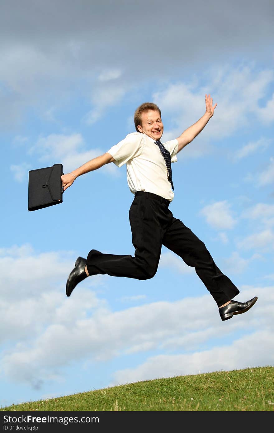 Happy businessman with bag jumps in the air. Happy businessman with bag jumps in the air