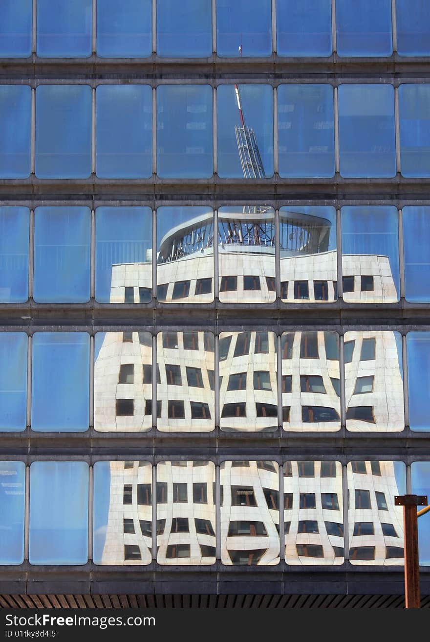 Reflection of skyscraper in windows of modern office building