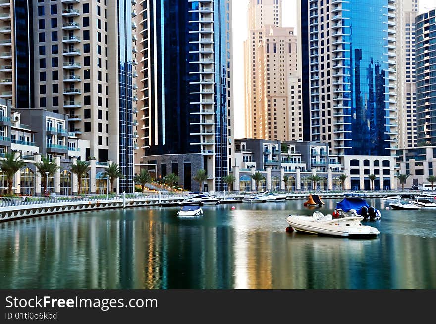 Luxury Yachts in Dubai Marina with waterfront Apartments in the background. Luxury Yachts in Dubai Marina with waterfront Apartments in the background