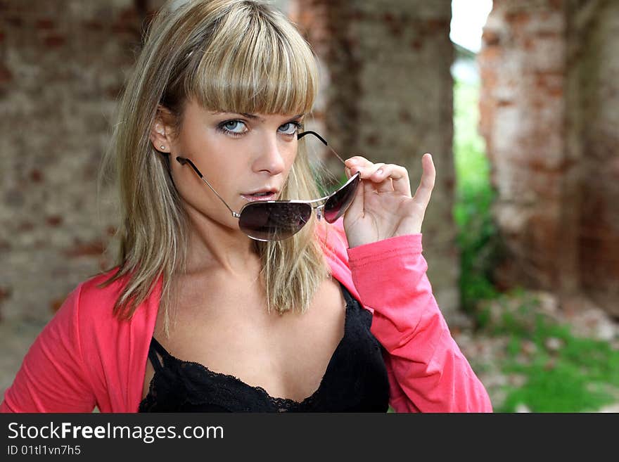 Girl with glasses at old house