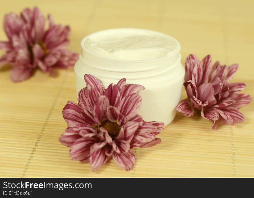 Spa essentials. Cream and flowers.