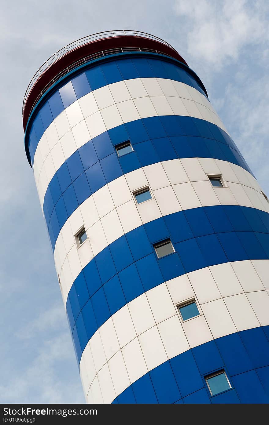 A blue and white striped potable water storage tower. A blue and white striped potable water storage tower