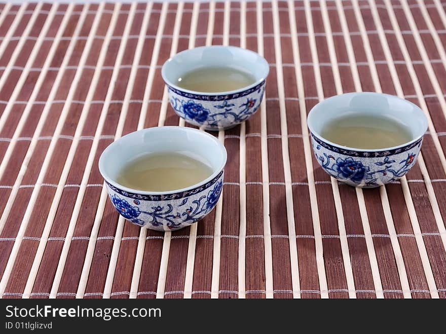 Blue and white porcelain teacups in bamboo background