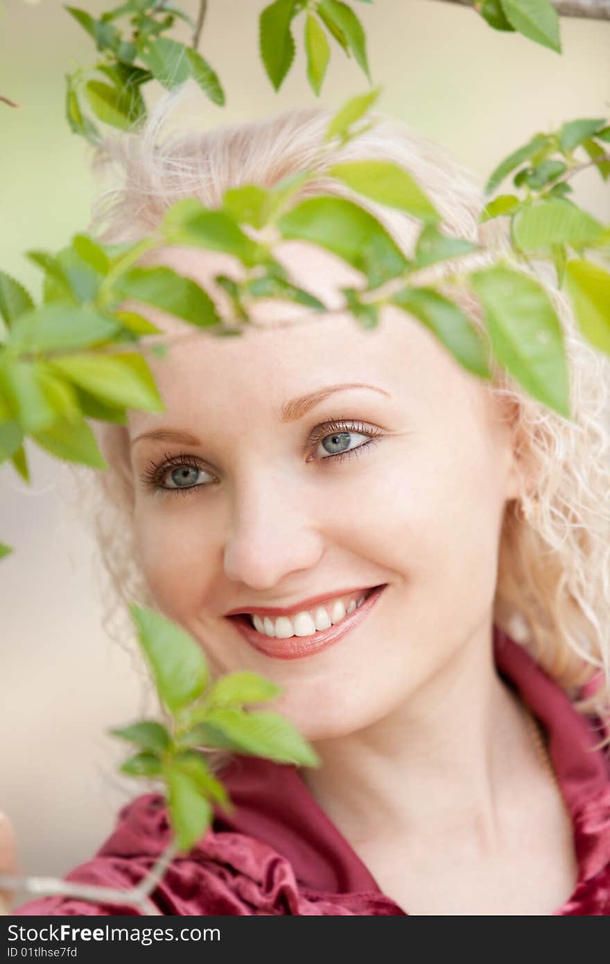 A girl in green leaves