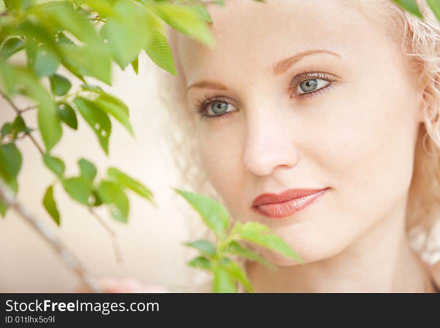 Portrait of a girl in green leaves