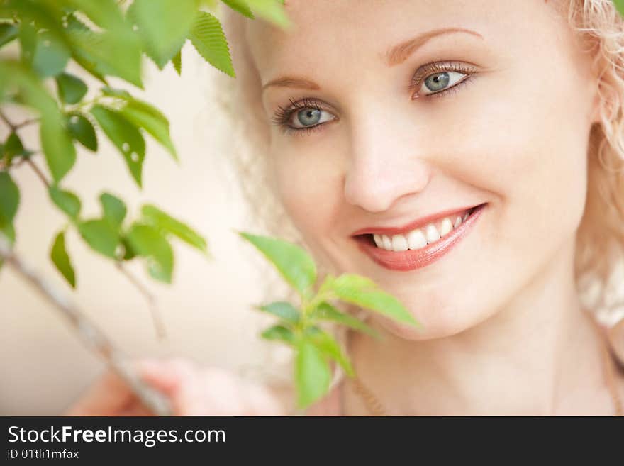 A girl in green leaves