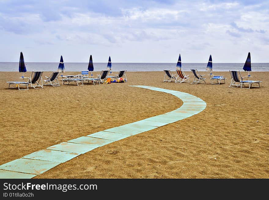 Path on the sand and umbrellas