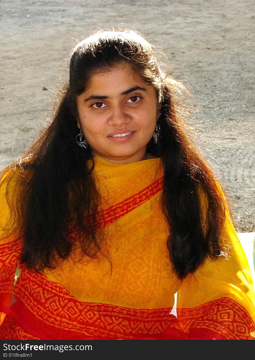 A smart Indian girl with her red traditional dresss. A smart Indian girl with her red traditional dresss.