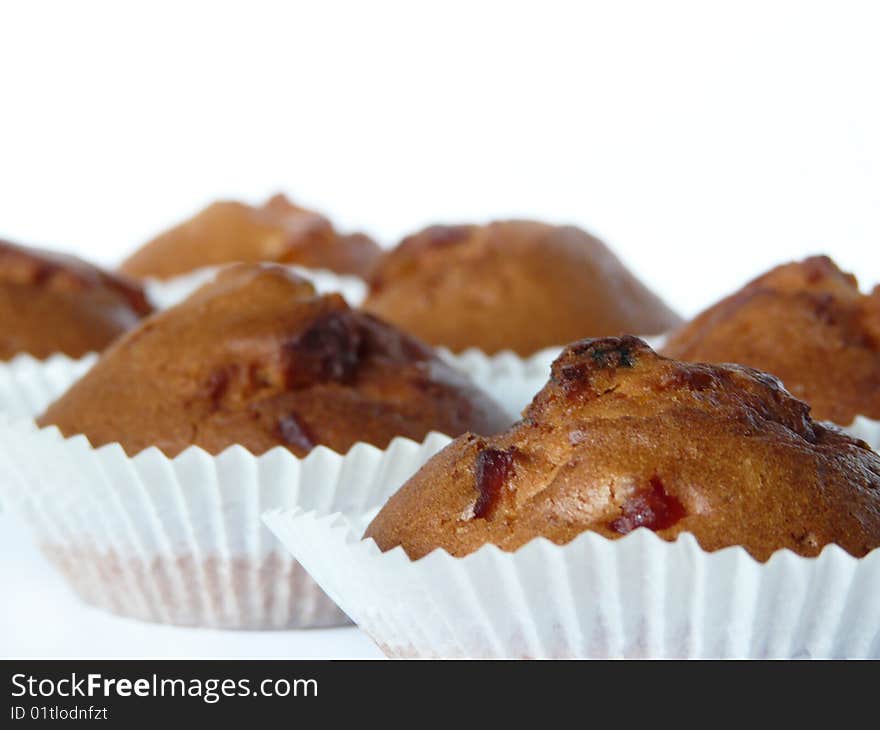 Fruit cupcakes isolated over white background. Shallow dof.