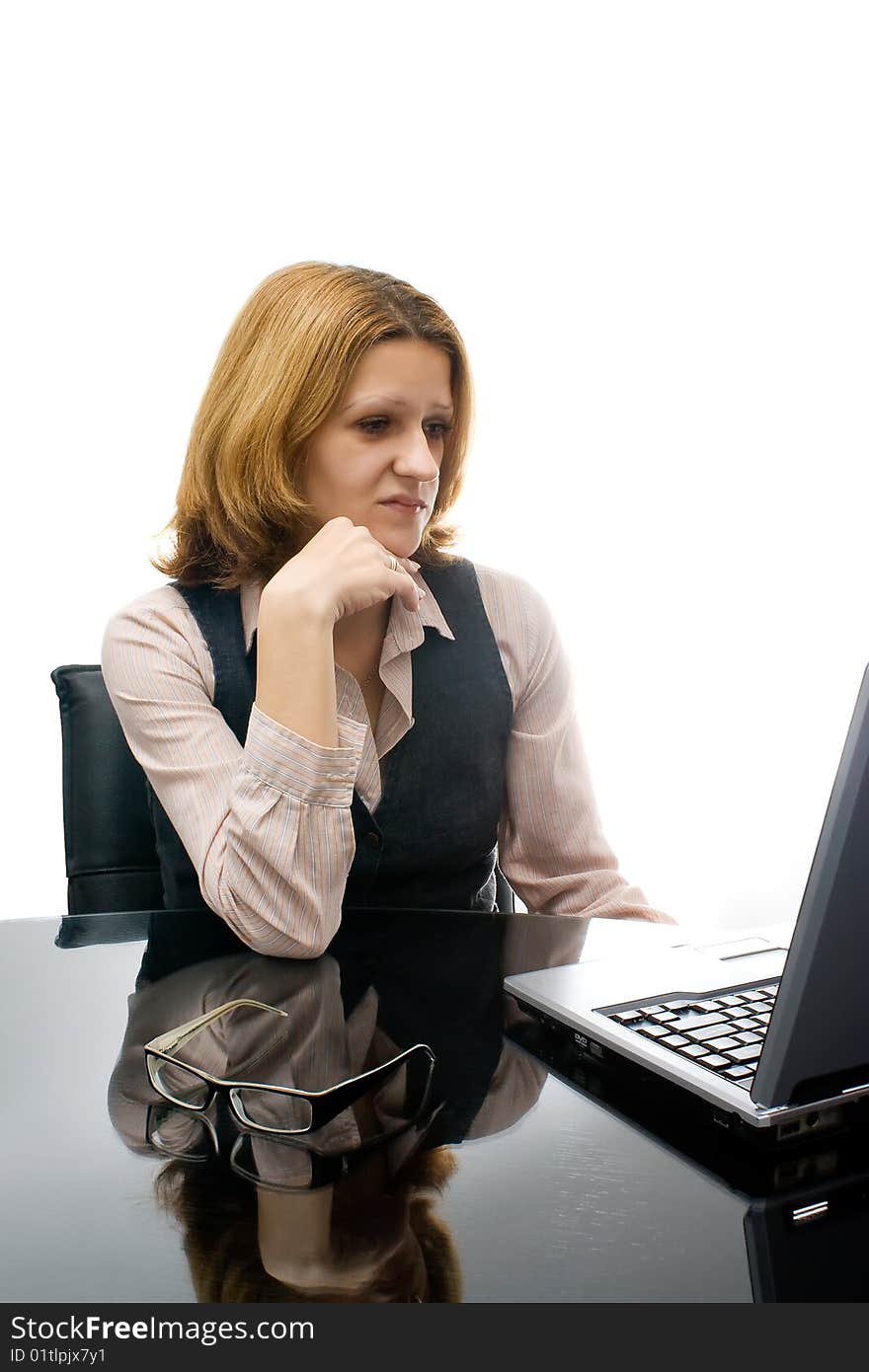 One young business woman working in office on laptop