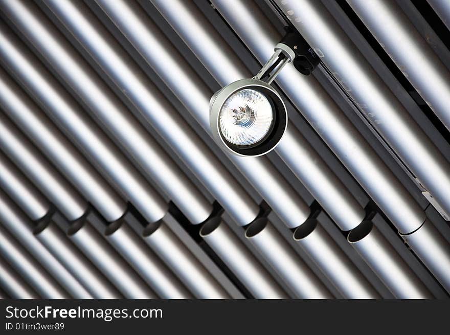 Spot Light suspended from a modern tubular steel ceiling.