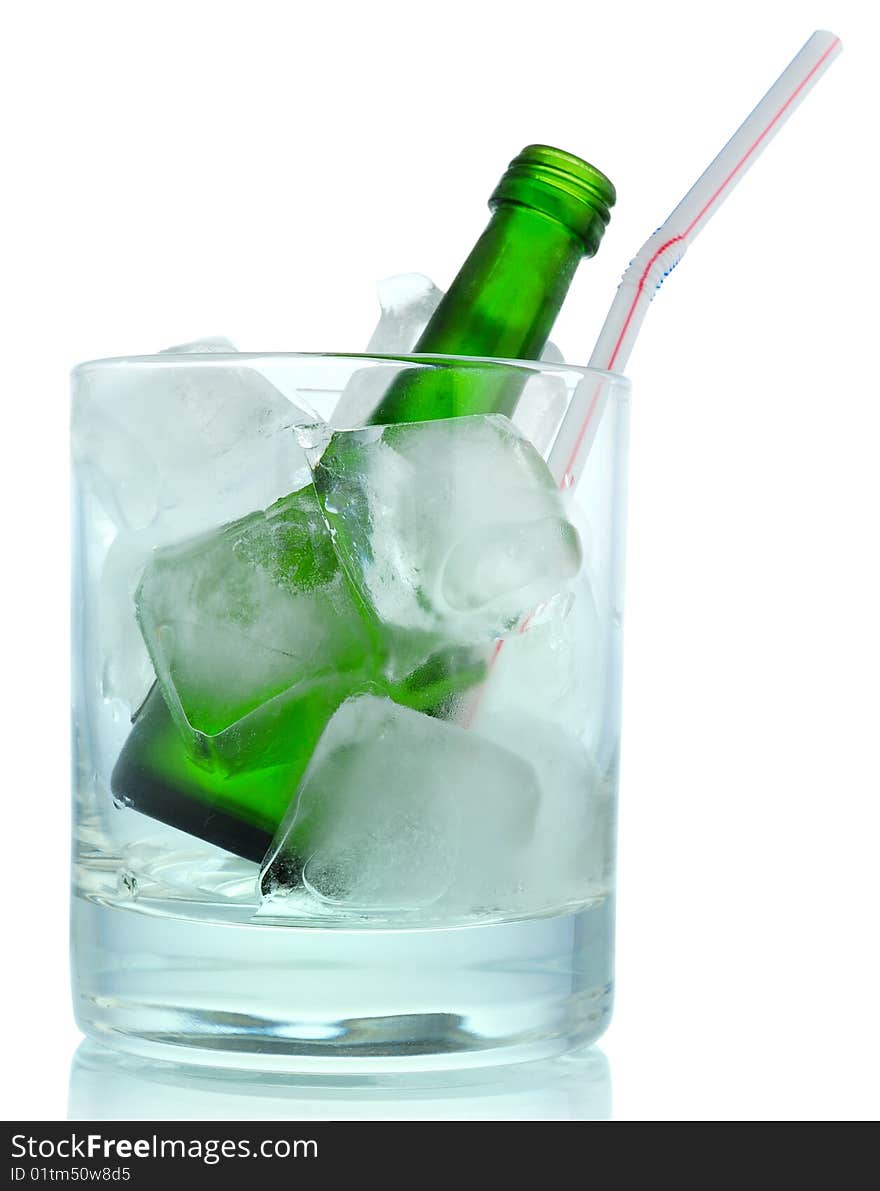 Cocktail: glass with ice and green bottle. Cocktail: glass with ice and green bottle